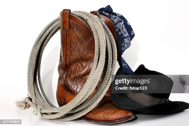 cowboy gear: boots, hat, rope and bandana. isolated on white. - cowboy hat stock pictures, royalty-free photos & images