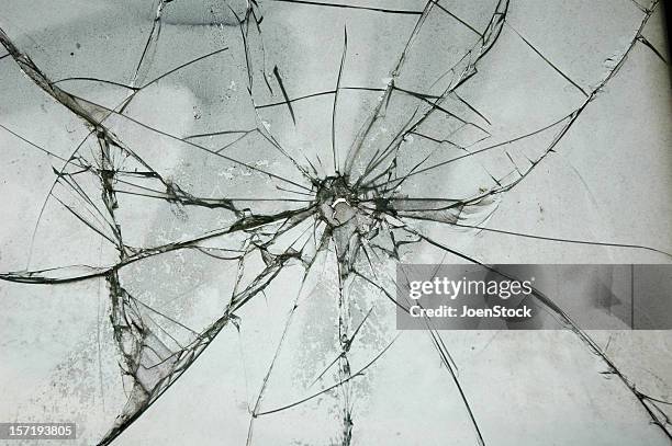 broken glass window bullet shooting impact hole cracks - bullet holes stockfoto's en -beelden