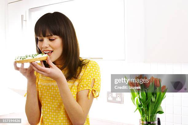 sano alimentazione - girls laughing eating sandwich foto e immagini stock