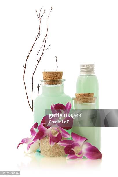 green soap bottles and flowers - packshot stockfoto's en -beelden