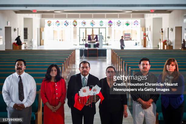 Martin Medina and his wife Rosario, and Pedro Salas and his wife Pilar, and Jose Montoya and his wife Maty pray at St. Jerome Catholic Community in...