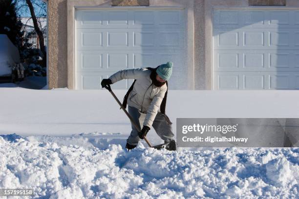 female snow shoveler - shoveling driveway stock pictures, royalty-free photos & images