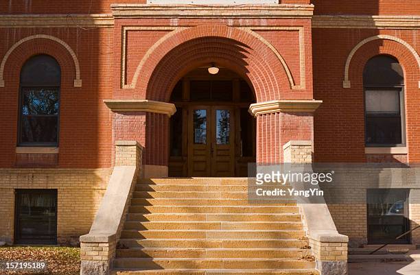 old brick school building exterior front entrance door and steps - high school building entrance stock pictures, royalty-free photos & images