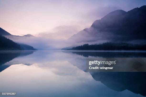 morning at lake plansee - moody sky horizon stock pictures, royalty-free photos & images