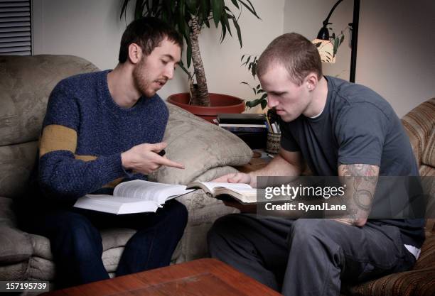 two young men having a bible study - christian college stock pictures, royalty-free photos & images