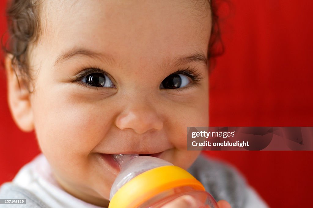 Baby drinking milk out of a bottle