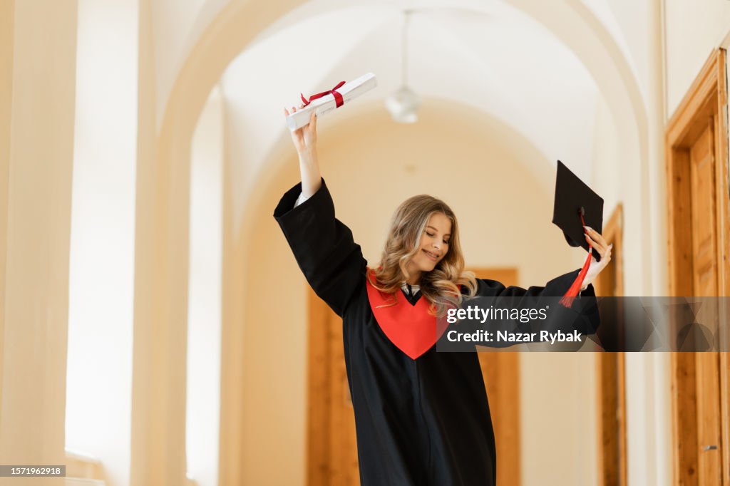 Graduation Received The Cheerful Female Graduate In A Gown Is Happy To Receive A Diploma ...