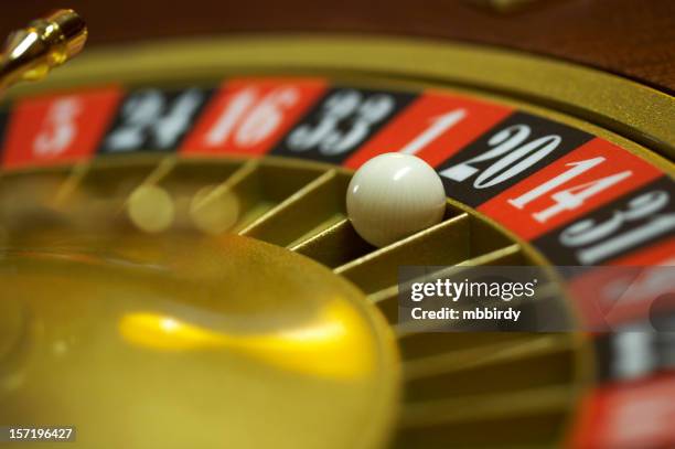 roulette wheel with ball on number 20, close up - roulette stock pictures, royalty-free photos & images