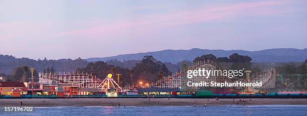 santa cruz boardwalk: roller coaster after sunset - santa cruz california beach stock pictures, royalty-free photos & images