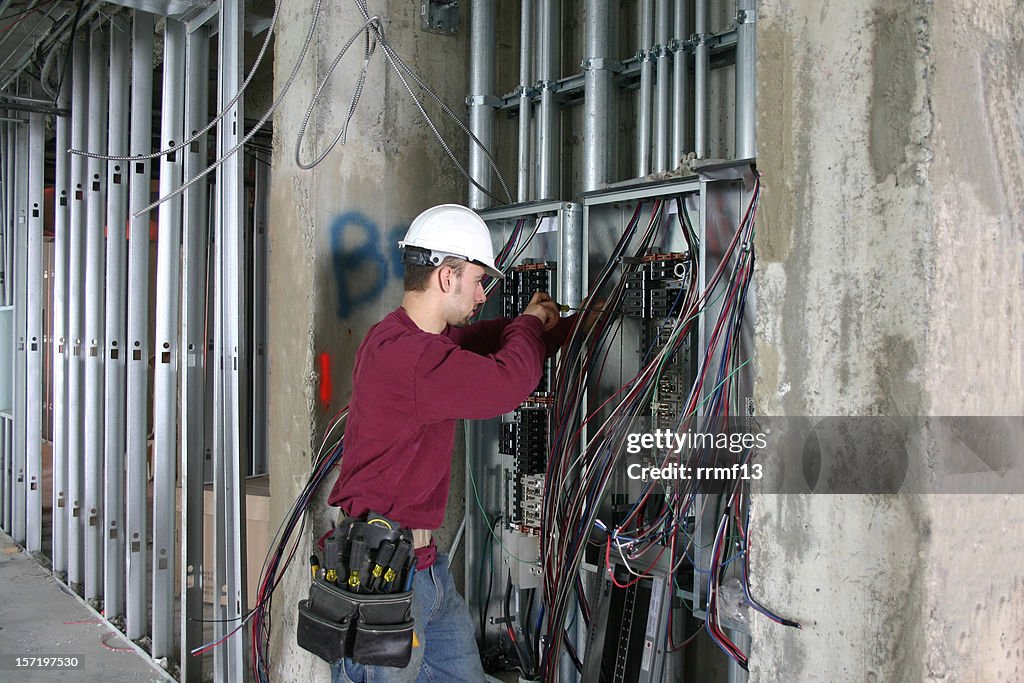 Electrician working in an Electrical Panel.