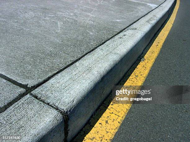 close up of curb on a street - trottoirband stockfoto's en -beelden