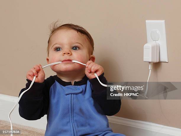 safety baby cord chew ii - electrical outlet stock pictures, royalty-free photos & images