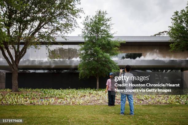 Faayad Jahangir has his photo taken by his mother Sophia as they stand in front of the Asia Society Texas Center during the "First Look Festival",...