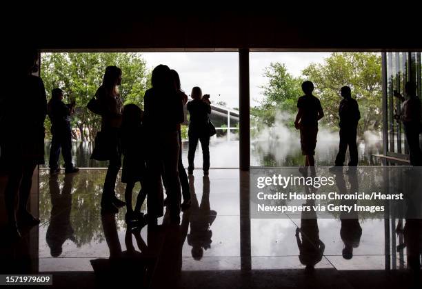 Visitors peer out into the reflecting pool at the Asia Society Texas Center during the "First Look Festival", Sunday, April 15 in Houston. The Asia...