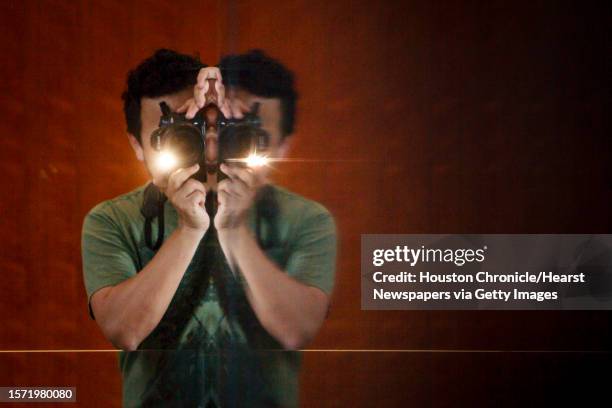 Alex Montoya looks around a glass wall as he takes a picture of the Asia Society Texas Center during the "First Look Festival", Sunday, April 15 in...