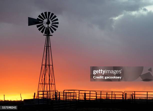 sunset windmill - ranch fence stock pictures, royalty-free photos & images