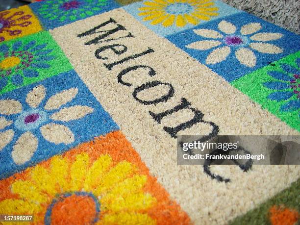 colorful doormat with a welcome sign - doormat stock pictures, royalty-free photos & images