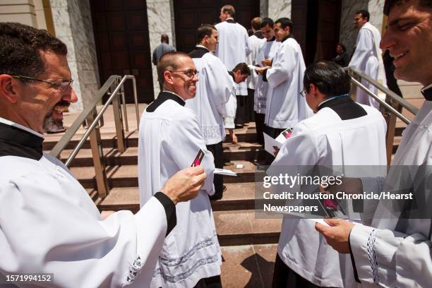 Seminarians hold photos of George Arthur Sheltz as they make their way to the service for Houston native George Arthur Sheltz to be ordained a...