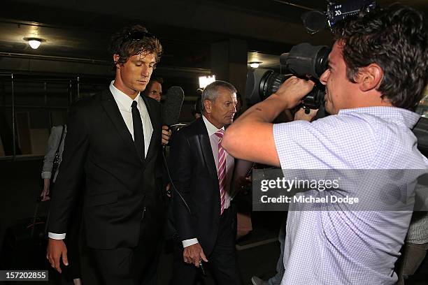 Adelaide Crows footballer Kurt Tippett walks out with David Galbally QC after the Adelaide Crows AFL Commission Hearing at AFL House on November 30,...