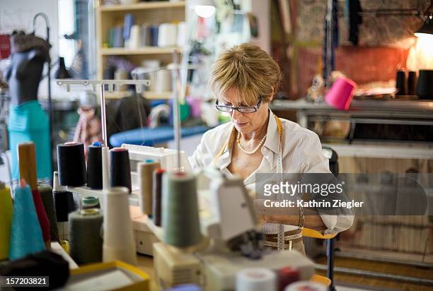senior fashion designer using sewing machine - woman sewing bildbanksfoton och bilder