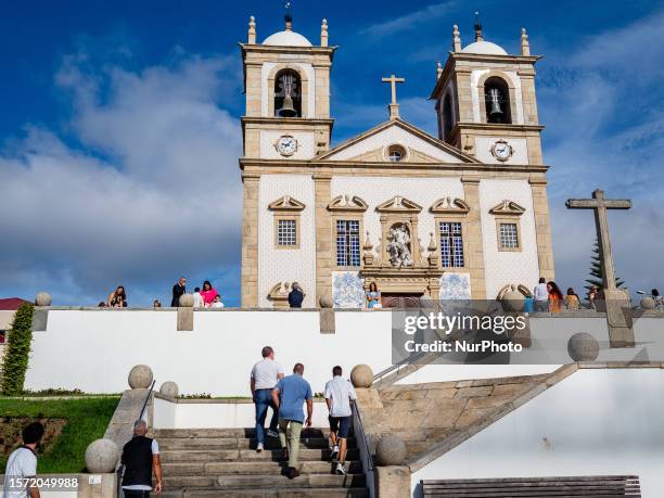 View of people entering the church ''Igreja Matriz de Oliveira de Azemeis'', decorated with azulejos. In Oliveira de Azemeis, Portugal, on June 2023.