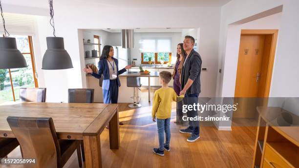 estate agent showing house to women - luxury home dining table people lifestyle photography people stock pictures, royalty-free photos & images