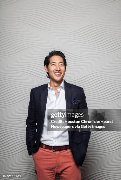 Charlie Chanaratsopon, who owns the Charming Charlie accessory chain, poses for a portrait at his home, Monday, Nov. 19 in Houston.