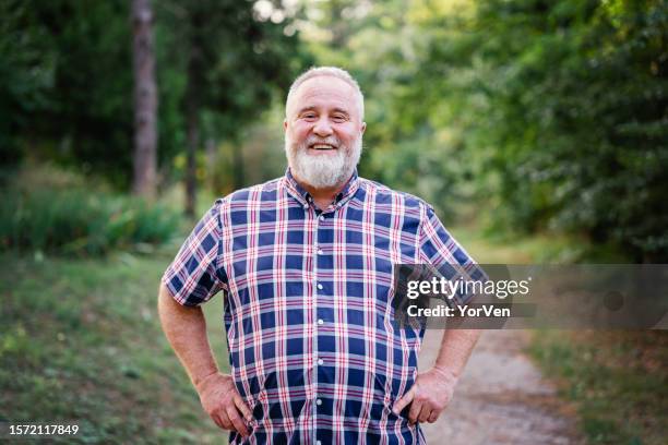 portrait of happy obese man walking in park - big beard stock pictures, royalty-free photos & images