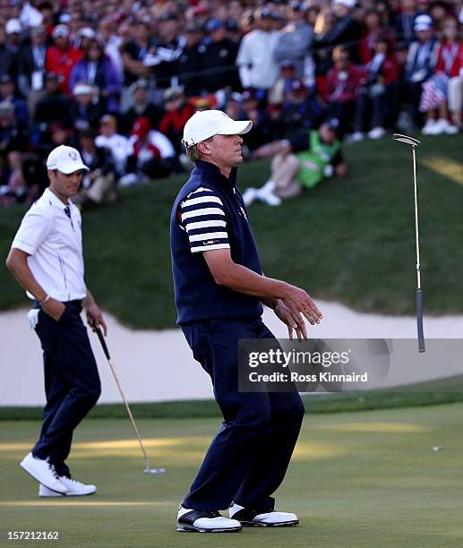 Martin Kaymer of Europe watches as Steve Stricker of the USA misses his putt on the the 17th hole during the Singles Matches for The 39th Ryder Cup...