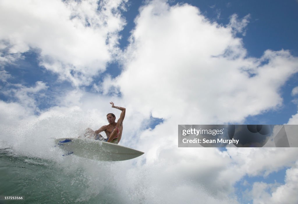 Low angle photograph of a man surfing