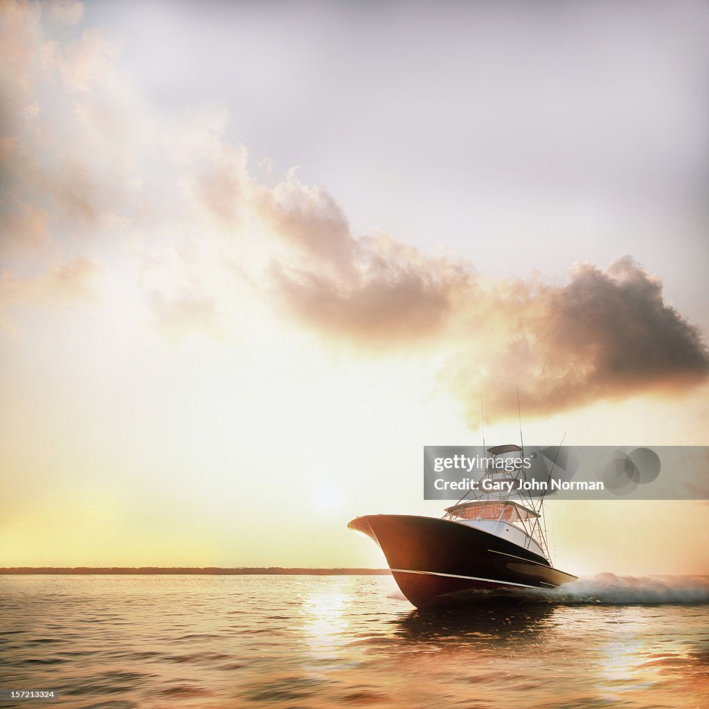 Motor yacht powering through calm water