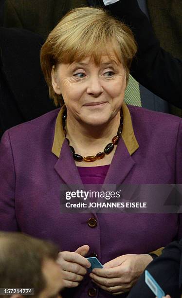 German Chancellor Angela Merkel casts her vote during a session at the Bundestag on November 30, 2012 in Berlin. Germany's parliament voted on...