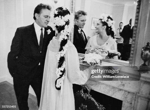 British film stars Elizabeth Taylor and Richard Burton at their first wedding in Montreal, Canada. They married twice, but both marriages ended in...