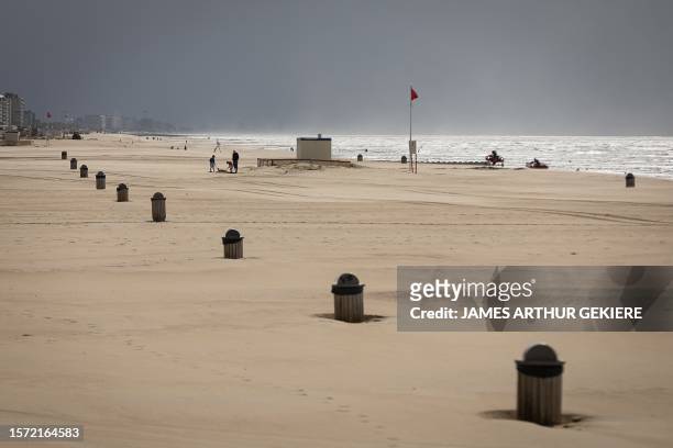 Illustration picture shows tourists in the rain during the summer holiday at the Belgian coast, in Oostende, on Wednesday 02 August 2023. The poor...