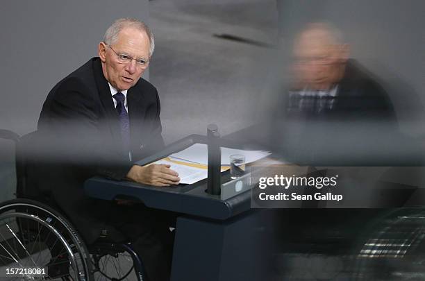 German Finance Minister Wolfgang Schaeuble speaks during debates over a financial aid package for stricken Greece at the Bundestag on November 30,...