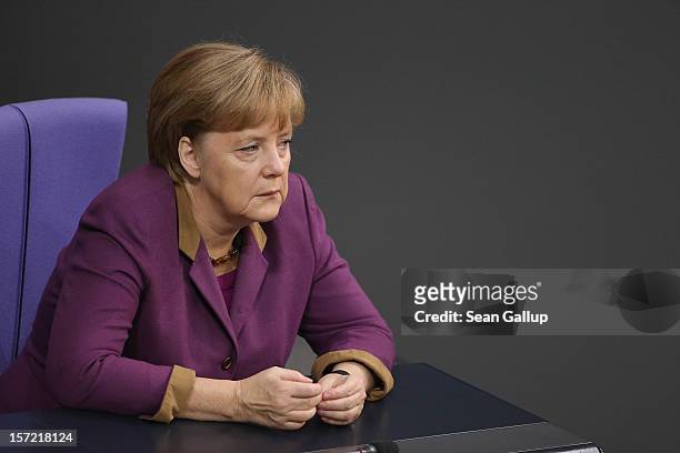 German Chancellor Angela Merkel listens to debates over a financial aid package for stricken Greece at the Bundestag on November 30, 2012 in Berlin,...