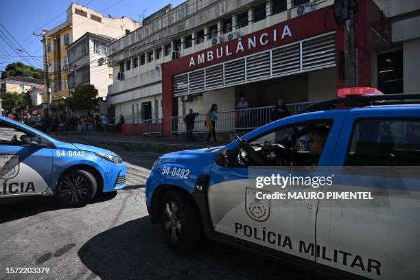 Vehicles of the Rio de Janeiro's Military Police are parked outside the Getulio Vargas hospital, where injured and dead people were admitted after a...