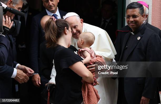 Pope Francis greets a baby after a meeting with the Portugal's Prime Minister Antonio Costa at Apostolic Nunciature on August 2, 2023 in Lisbon,...