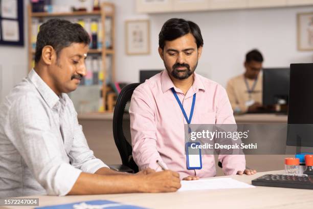 business person with customer in office, stock photo - south indian ethnicity stock pictures, royalty-free photos & images