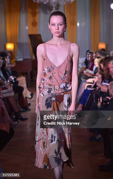 Models attends a catwalk show and auction hosted by Browns, Harpers Bazaar and H.E. Alain Giorgio Maria Economides in aid of Women for Women...