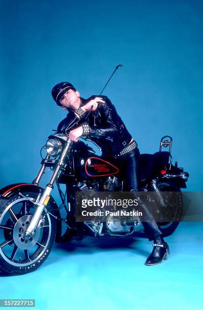 Portrait of British singer Rob Halford of the heavy metal group Judas Priest poses on a motorcycle backstage at the International Ampitheater,...