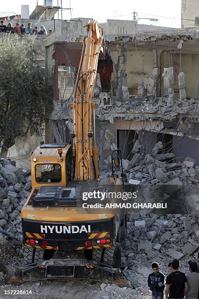 Rafet Dabash , a Palestinian from the east Jerusalem district of Sur Baher, has his house destroyed by a bulldozer on November 30, 2012 after an...