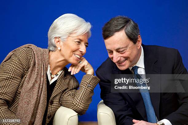 Christine Lagarde, managing director of the International Monetary Fund , left, speaks with Mario Draghi, president of the European Central Bank ,...