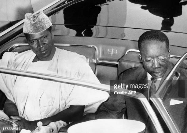 Ahmed Sekou Toure , President of Guinea, and Leopold Sedar Senghor, President of Senegal pose in the official car, on May 5, 1963 during Sekou Toure...