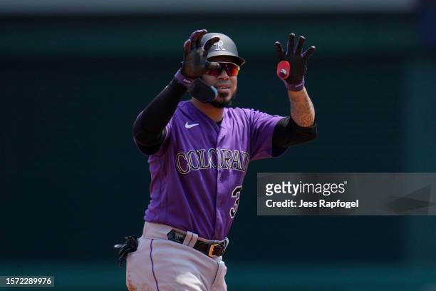 Harold Castro of the Colorado Rockies gestures after he hits a double against the Washington Nationals during the second inning at Nationals Park on...