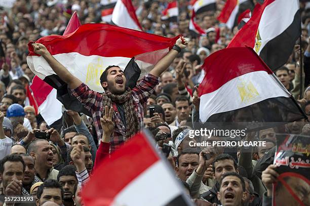 Egyptian anti-goverment demonstrators wave Egyptian flags at Cairo's Tahrir Square on February 10, 2011 on the 17th day of protests against President...
