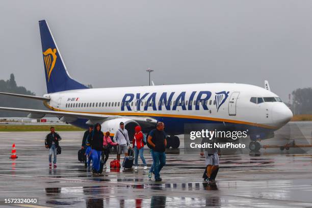 Passengers are leaving Ryanair airplane at Charleroi Airport near Brussels, Belgium on July 27, 2023