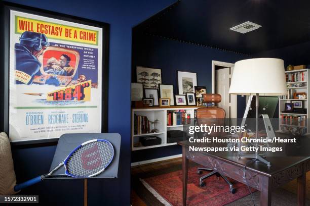 Window seat with vintage 1984 poster hangs in Justin Cronin's home office where he writes his best-selling books, Monday, July 22 in Houston. The...