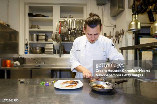 Chef German Mosquera plates the Grilled Prawns with Smoked Eggplant, Roast Hazelnuts and Membrillo at Restaurant CINQ inside La Colombe d'Or Hotel,...