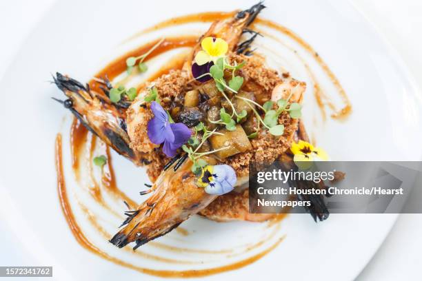 The Grilled Prawns with Smoked Eggplant, Roast Hazelnuts and Membrillo at Restaurant CINQ inside La Colombe d'Or Hotel, Tuesday, Aug. 13 in Houston.